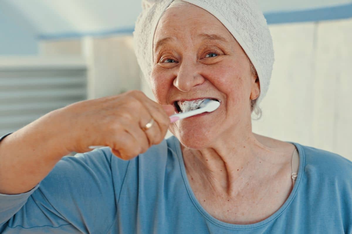 Dental implant care with brushing twice daily to maintain healthy gums