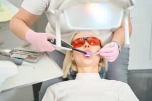 Dentist performing laser periodontal therapy to treat gum disease in Lubbock